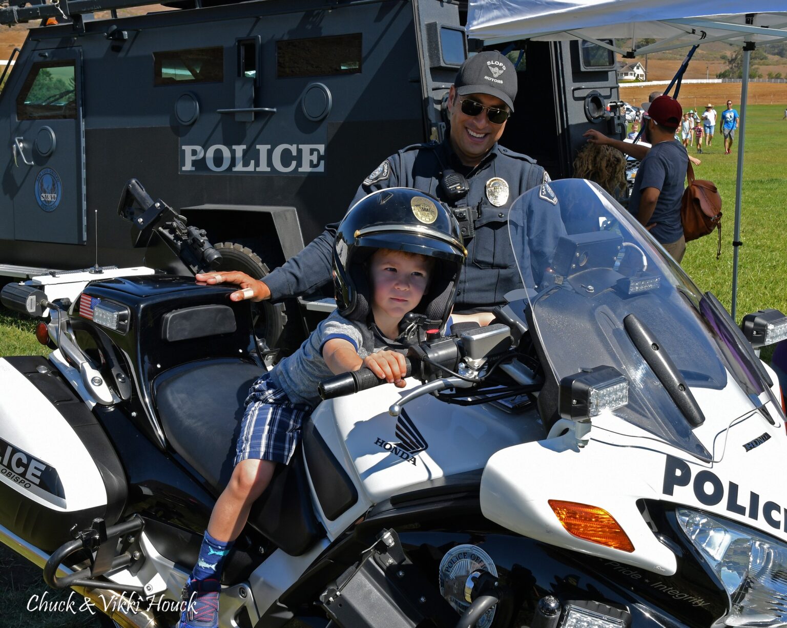 Child sitting on a police motorcycle at Cops 'N Kids Field Day in Arroyo Grande
